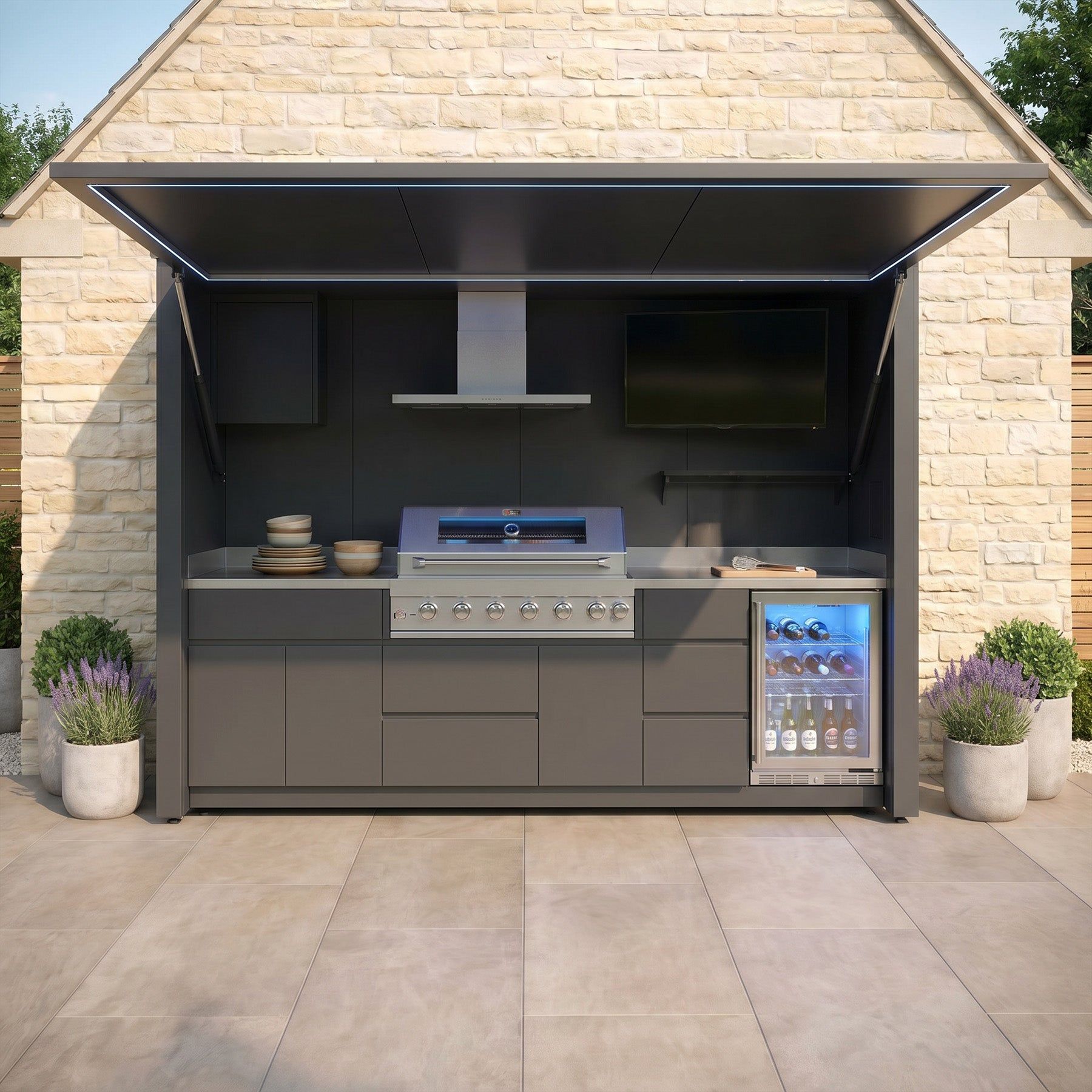 An outdoor kitchen cube with the door up, seen straight on in daylight, the grill, hood and fridge inside (supplier photograph)